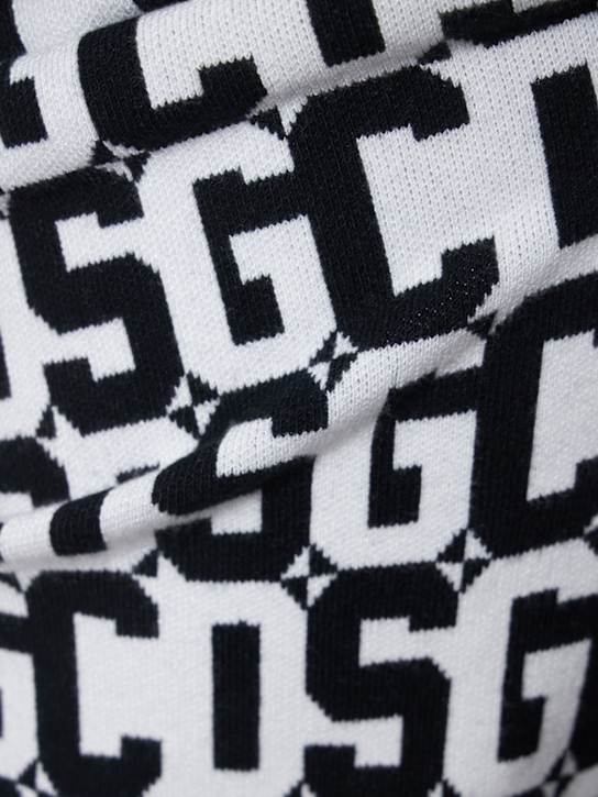 GCDS: Pantalones acampanados de punto con monograma