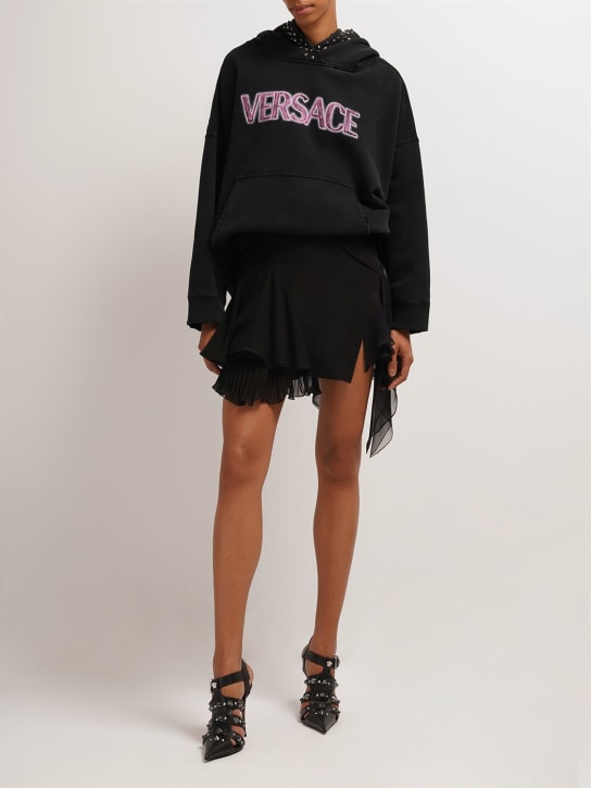 Versace: Jupe courte asymétrique en georgette de soie