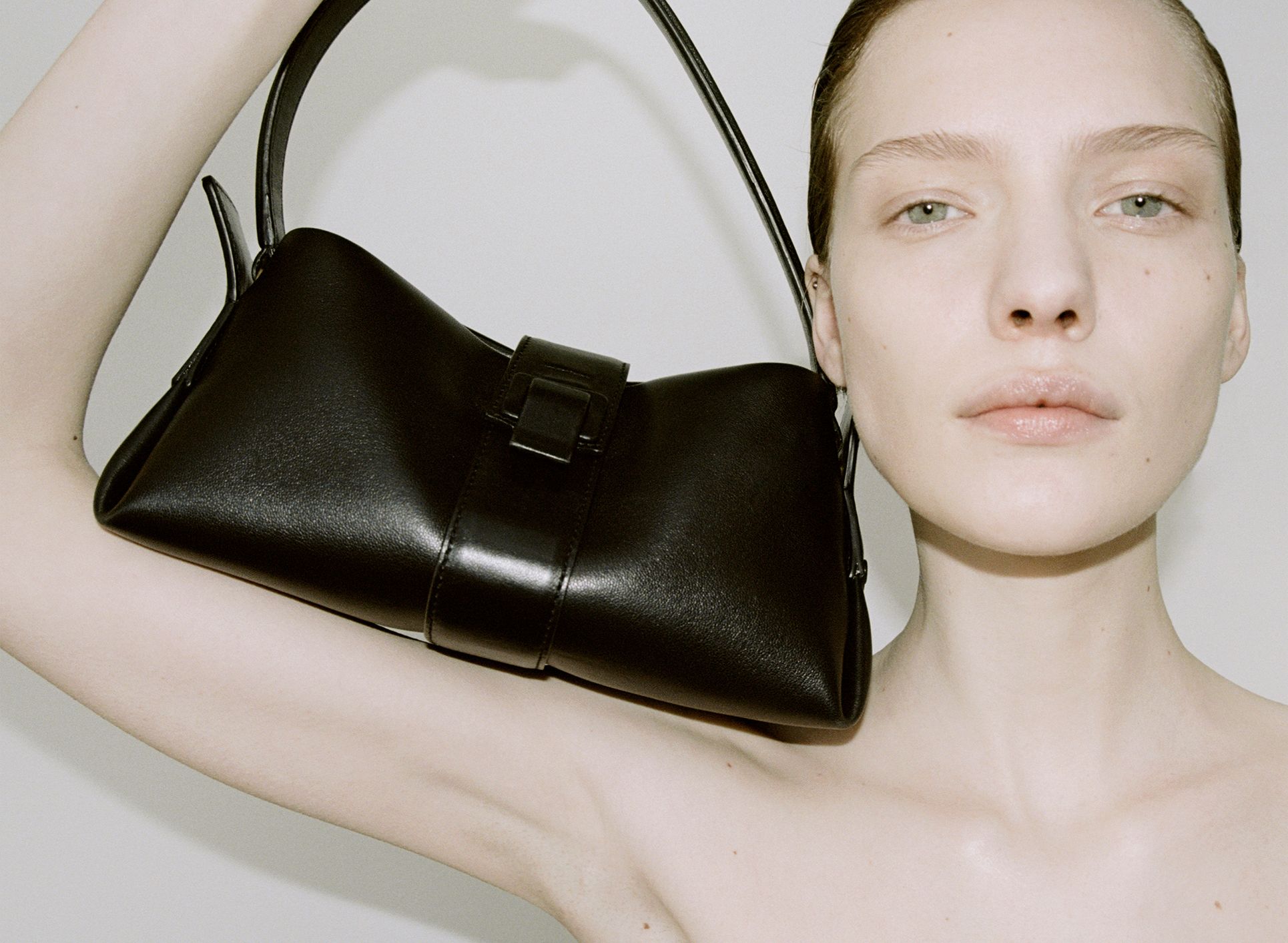 Model shows off Proenza Schouler black leather shoulder bag